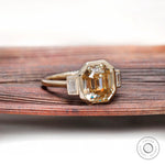 Bezel set emerald cut moissanite three stone ring with baguette sides