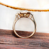 Yellow gold bezel set three stone moissanite ring close up