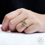 Light champagne emerald moissanite ring worn on hand