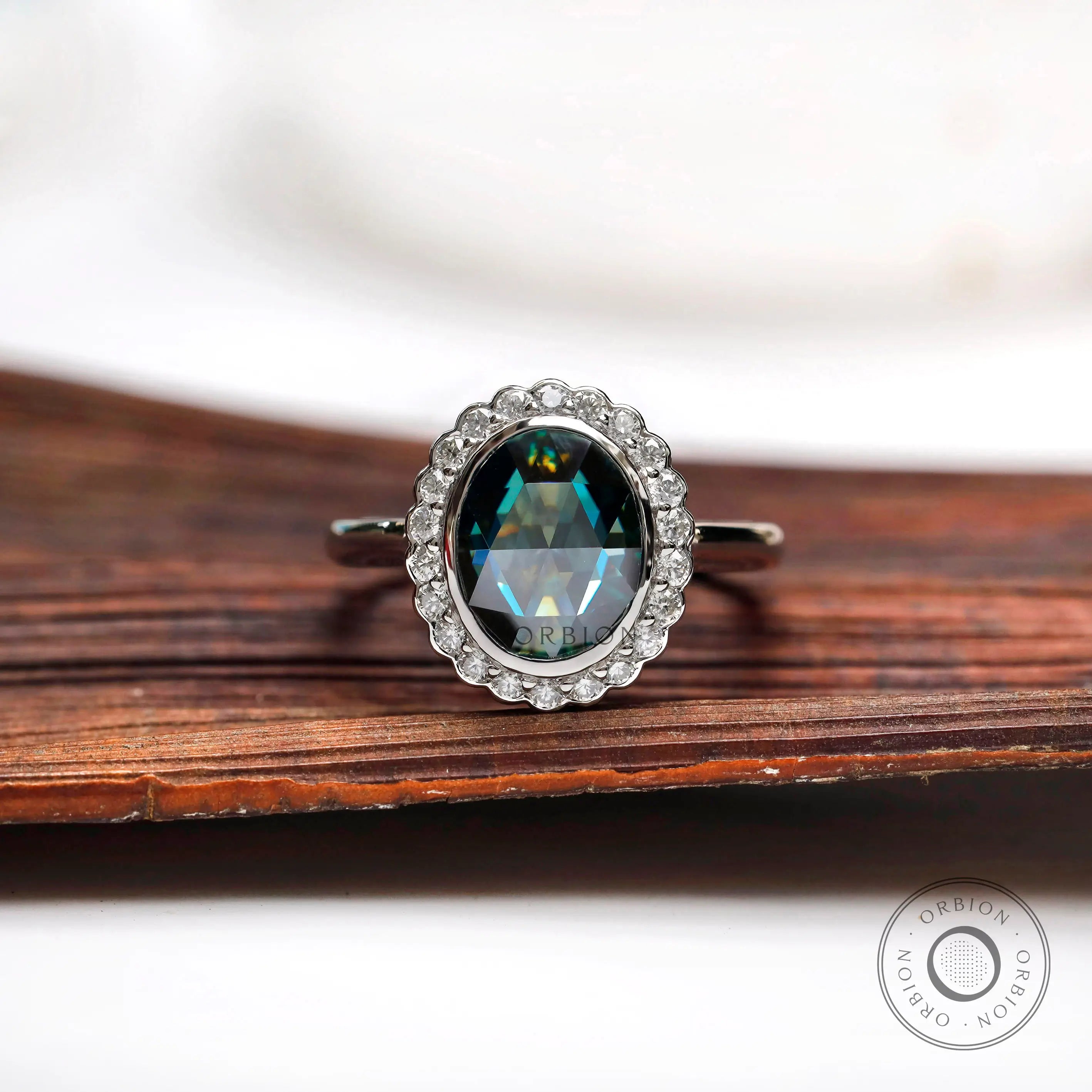 Oval bluish green rose cut moissanite halo ring in 10K white gold front view