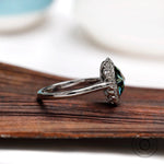 Side angle of oval rose cut bluish green moissanite halo engagement ring