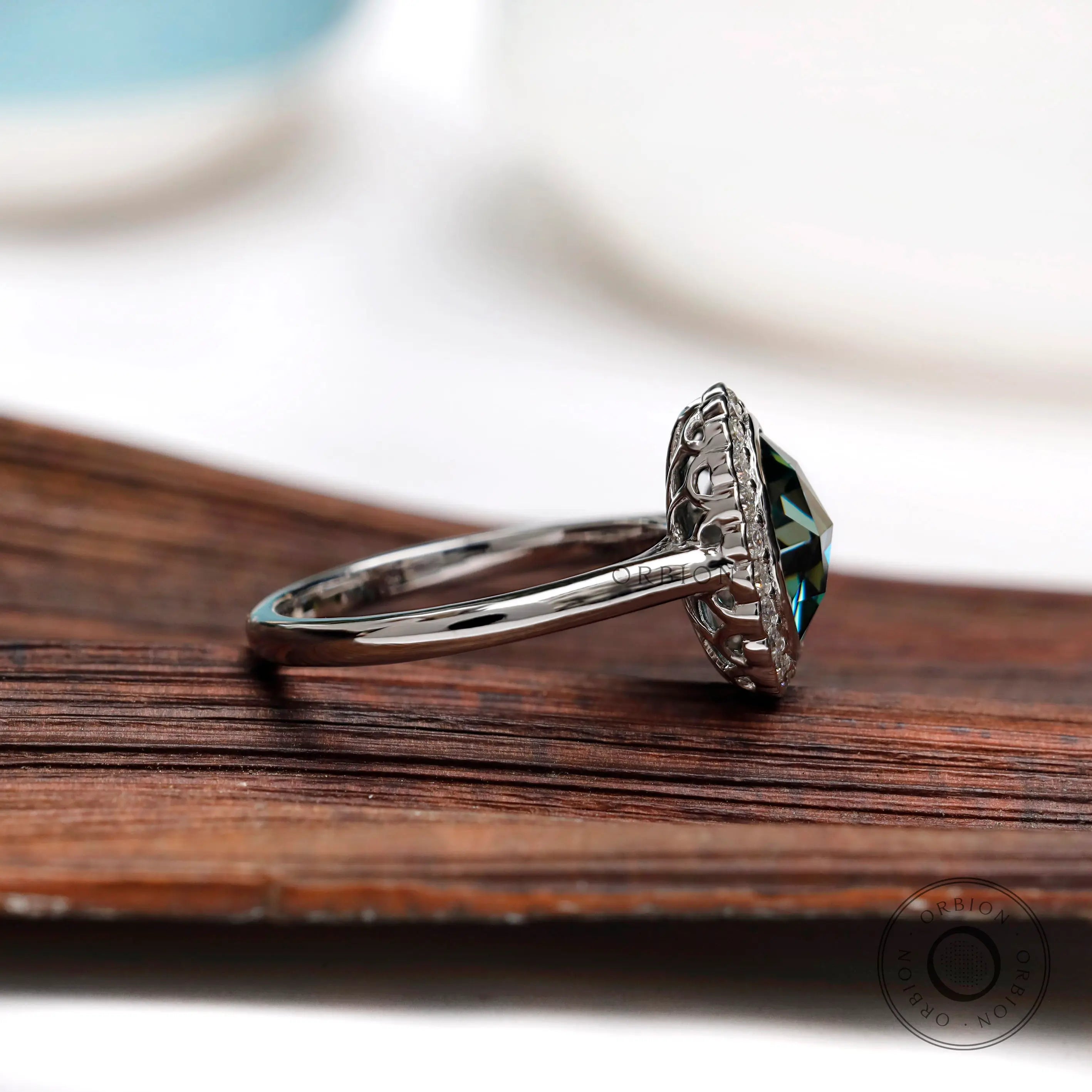 Side angle of oval rose cut bluish green moissanite halo engagement ring