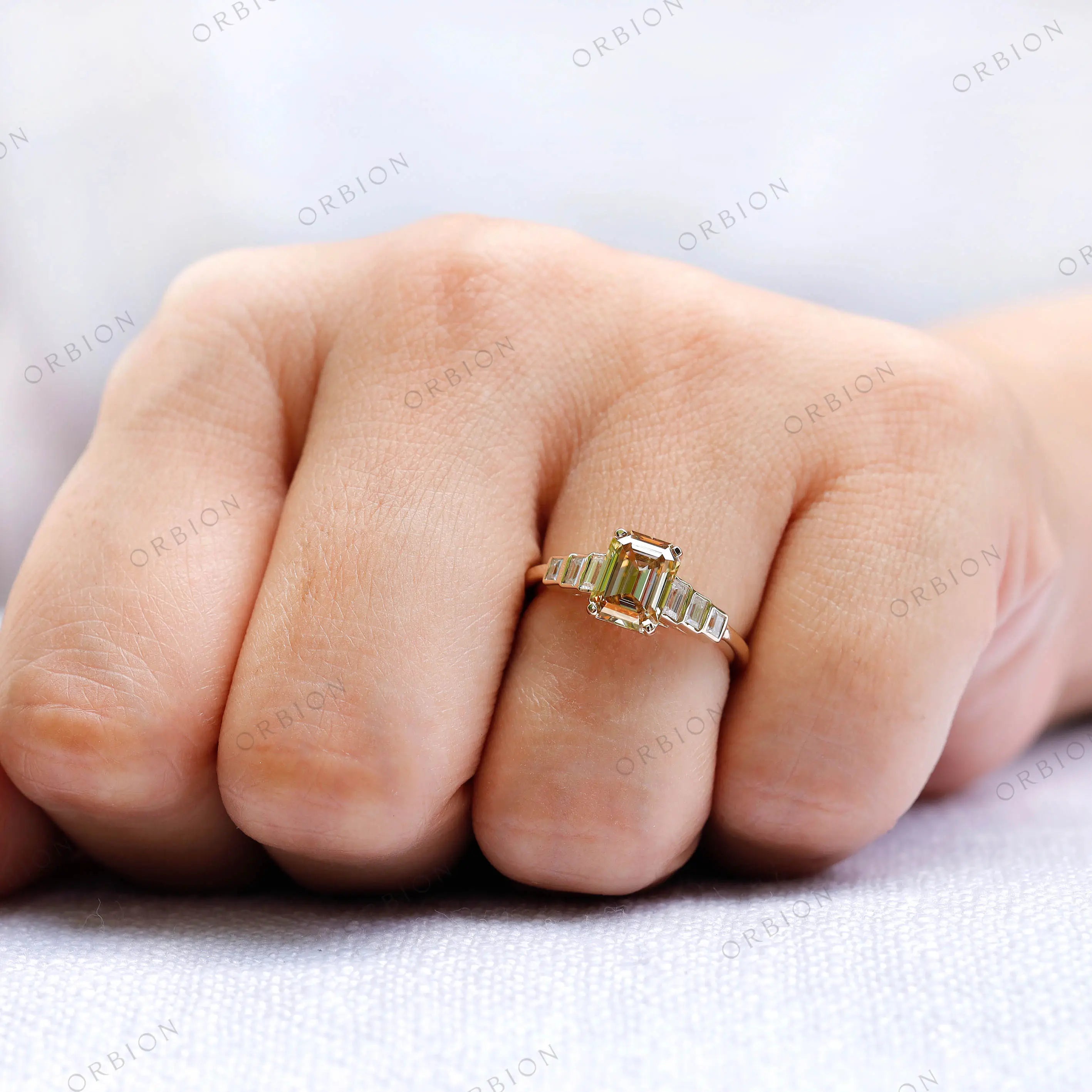 Elegant champagne moissanite 3 stone engagement ring worn on hand
