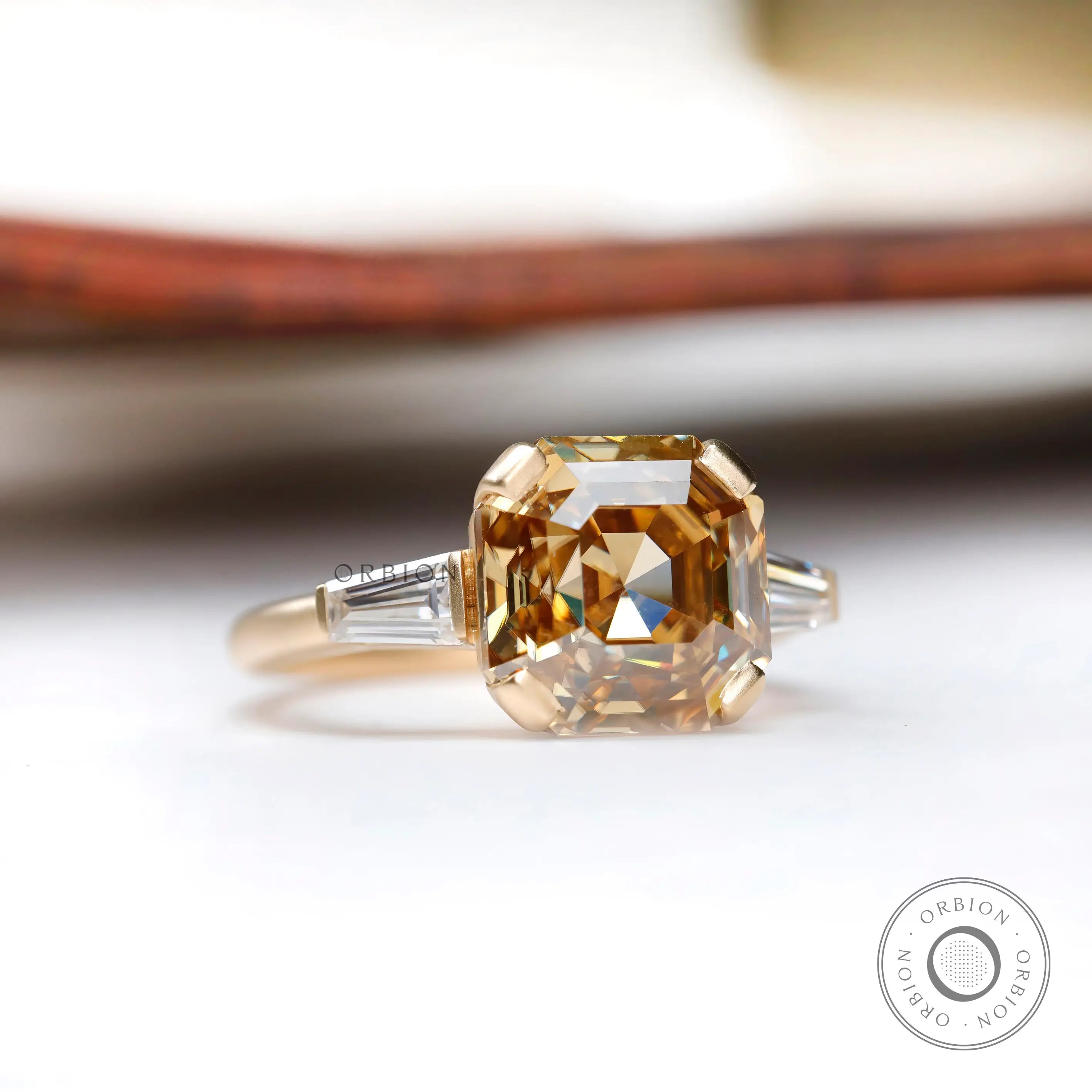 Three stone ring with octagon dark champagne moissanite in yellow gold