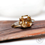 Top view of octagon step cut champagne moissanite three stone ring