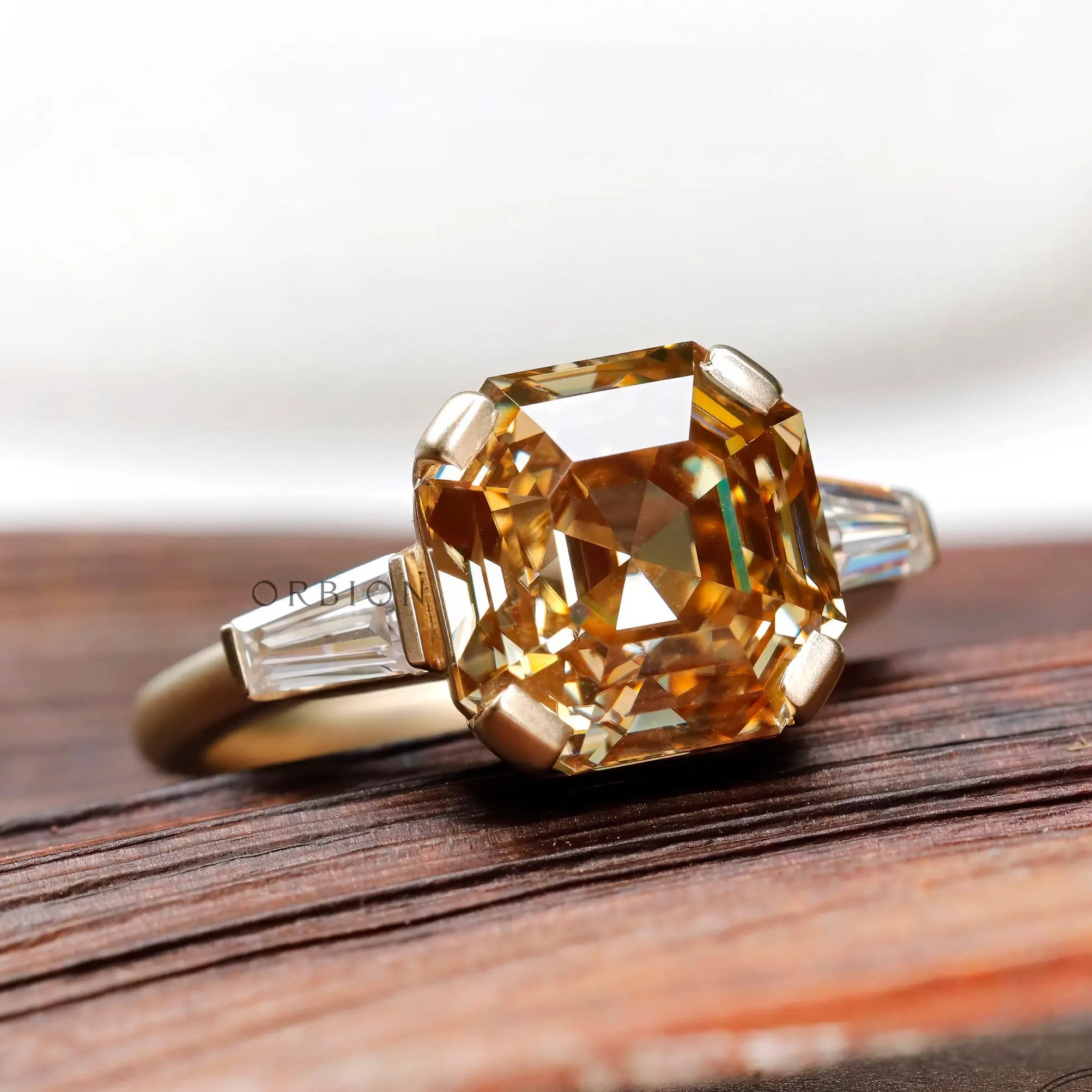 Top view of octagon step cut champagne moissanite three stone ring