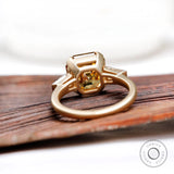 Under gallery of octagon champagne moissanite three stone ring