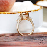 Basket setting detail of three stone moissanite ring in 10K gold