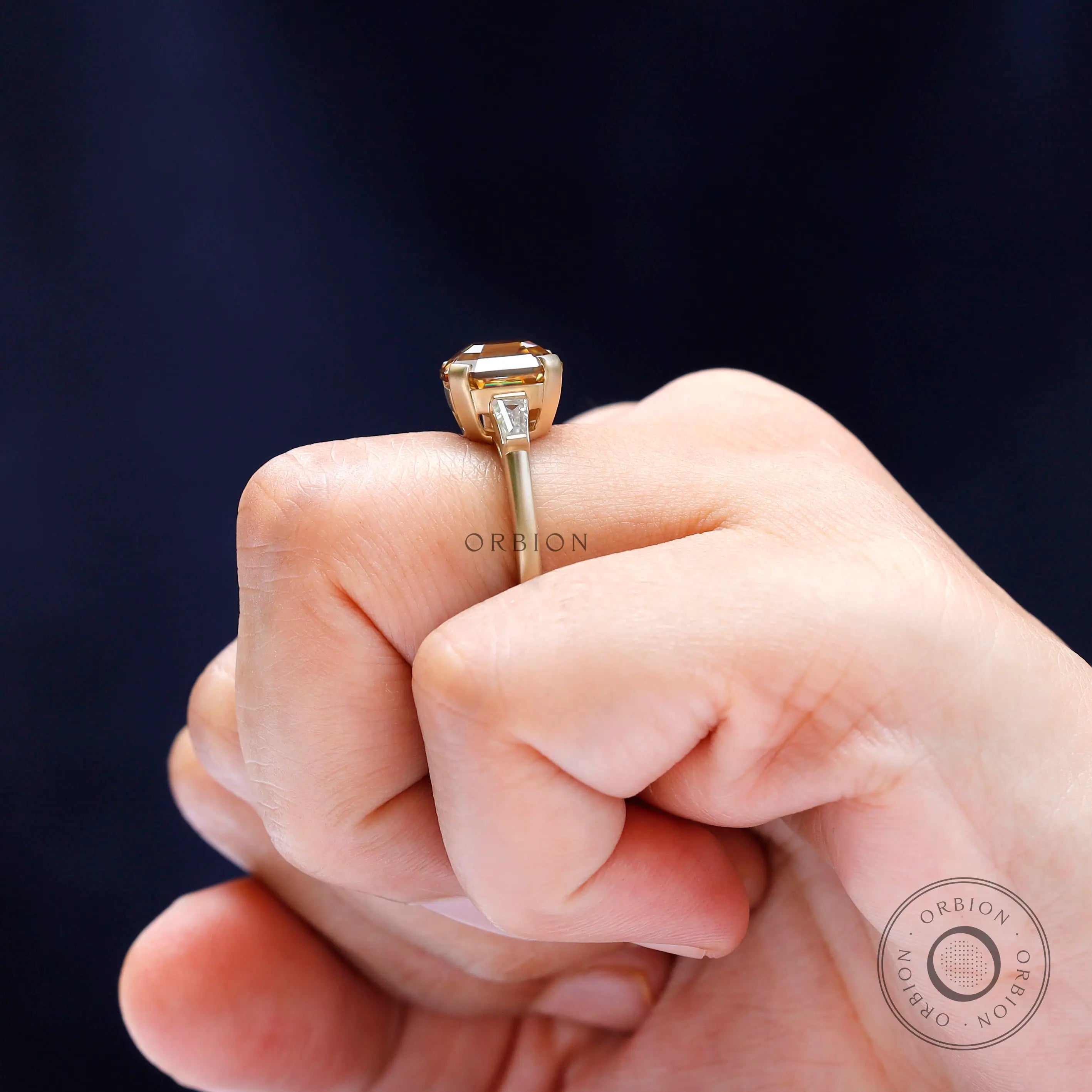 Baguette side stone detailing on three stone engagement ring