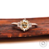 Front view of Champagne OEC Moissanite ring with baguette accents in rose gold.