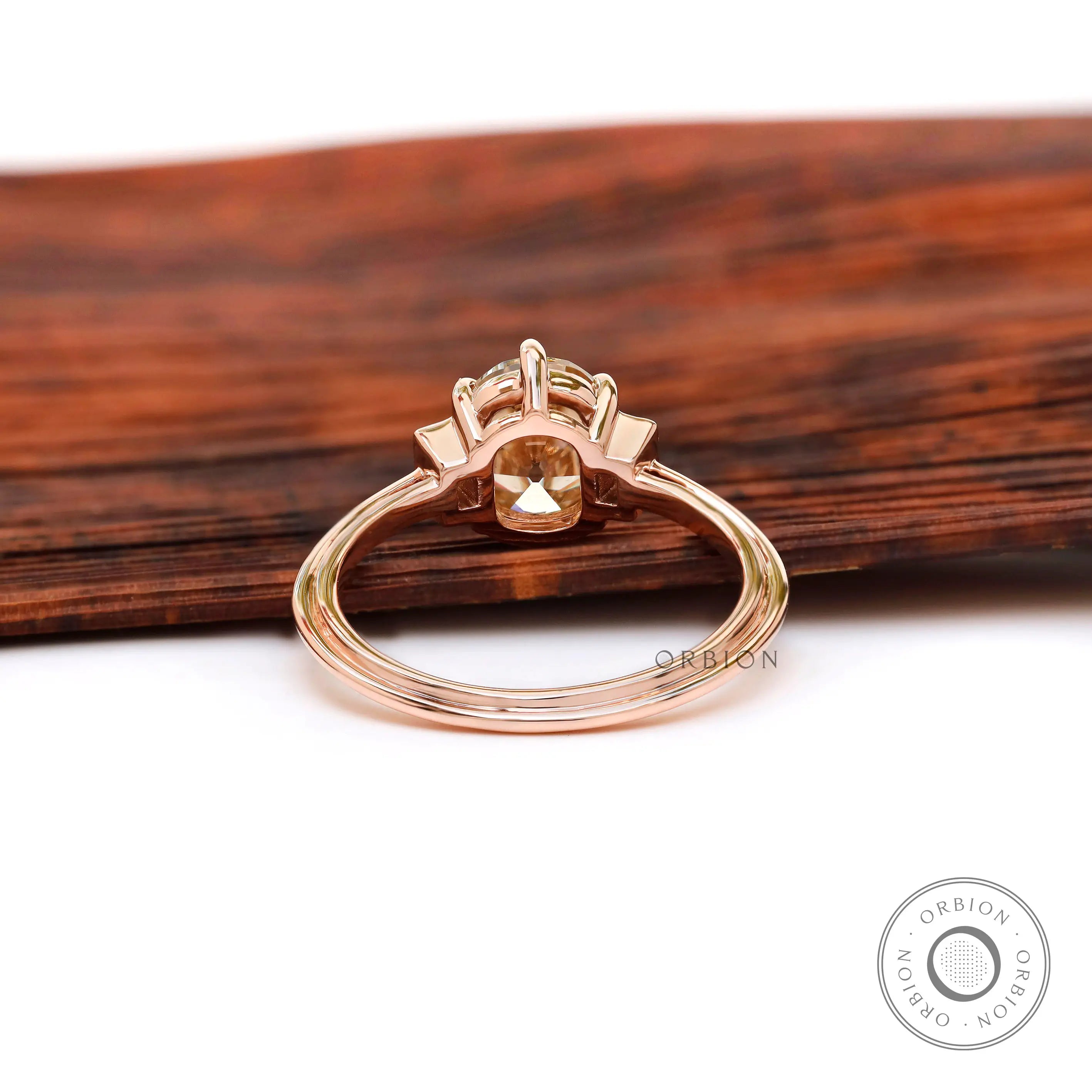 Back view of Champagne OEC Moissanite ring in rose gold with baguette accents.