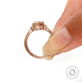Hand Held Champagne OEC Moissanite ring with baguette accents in rose gold.
