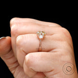 Close-up side of Champagne OEC Moissanite stone set with baguette accents in rose gold
