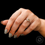 Champagne OEC Moissanite three-stone ring worn on finger with baguette accents.
