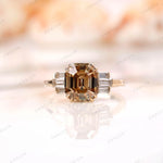 Front view of emerald cut champagne moissanite ring with baguettes