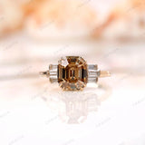 Front view of emerald cut champagne moissanite ring with baguettes