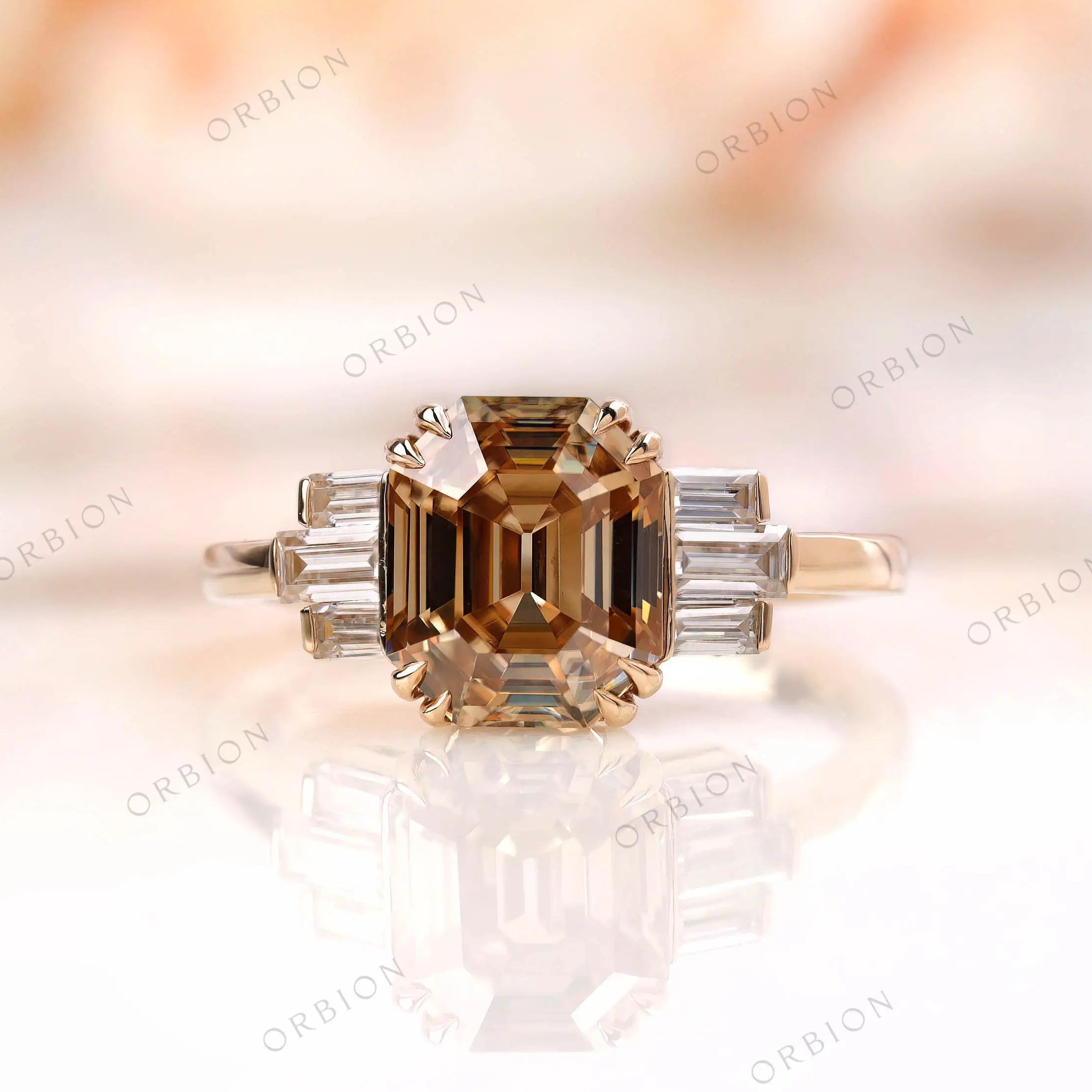 Front view of emerald cut champagne moissanite ring with baguettes