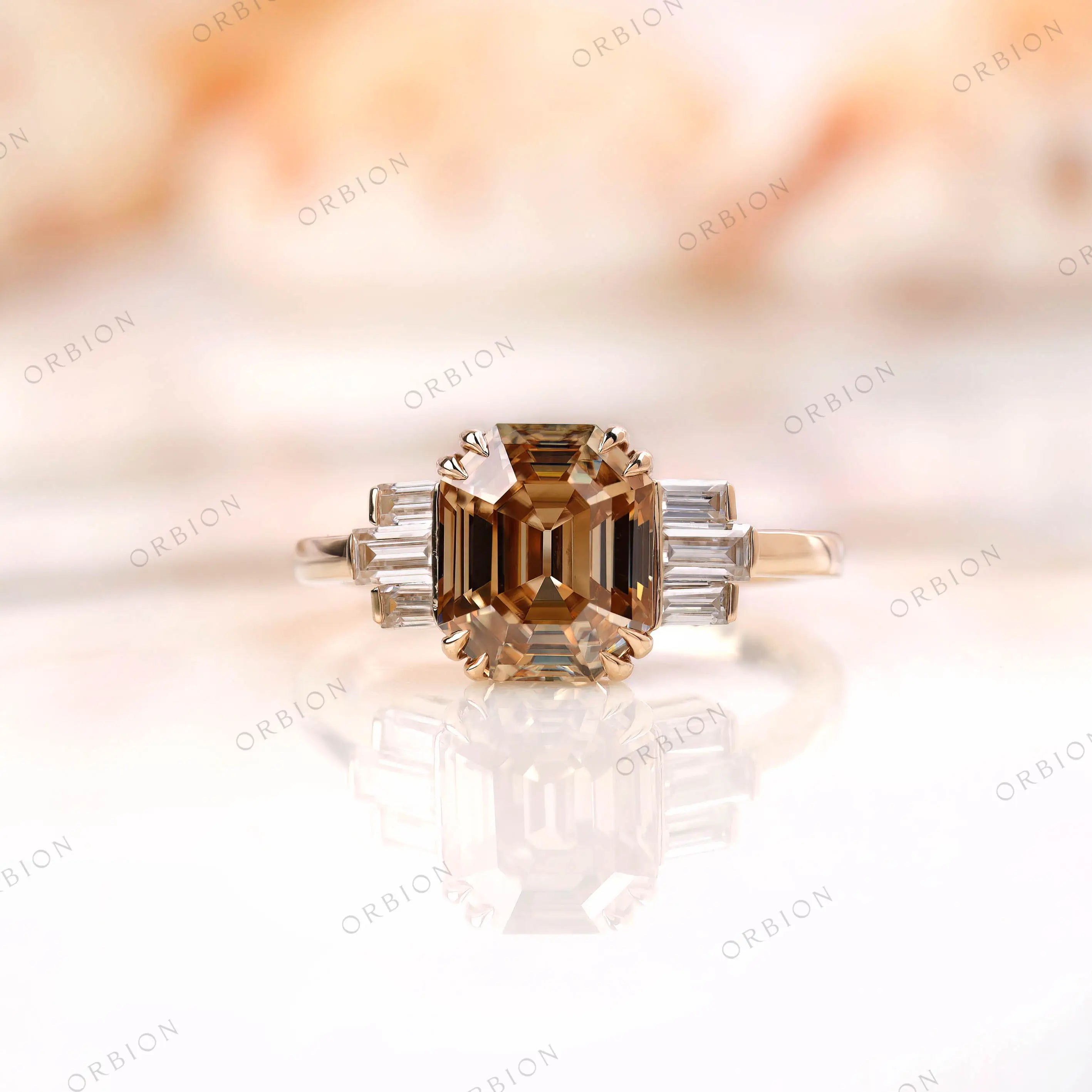 Front view of emerald cut champagne moissanite ring with baguettes