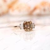 Side view of engagement ring showcasing emerald cut moissanite with baguettes