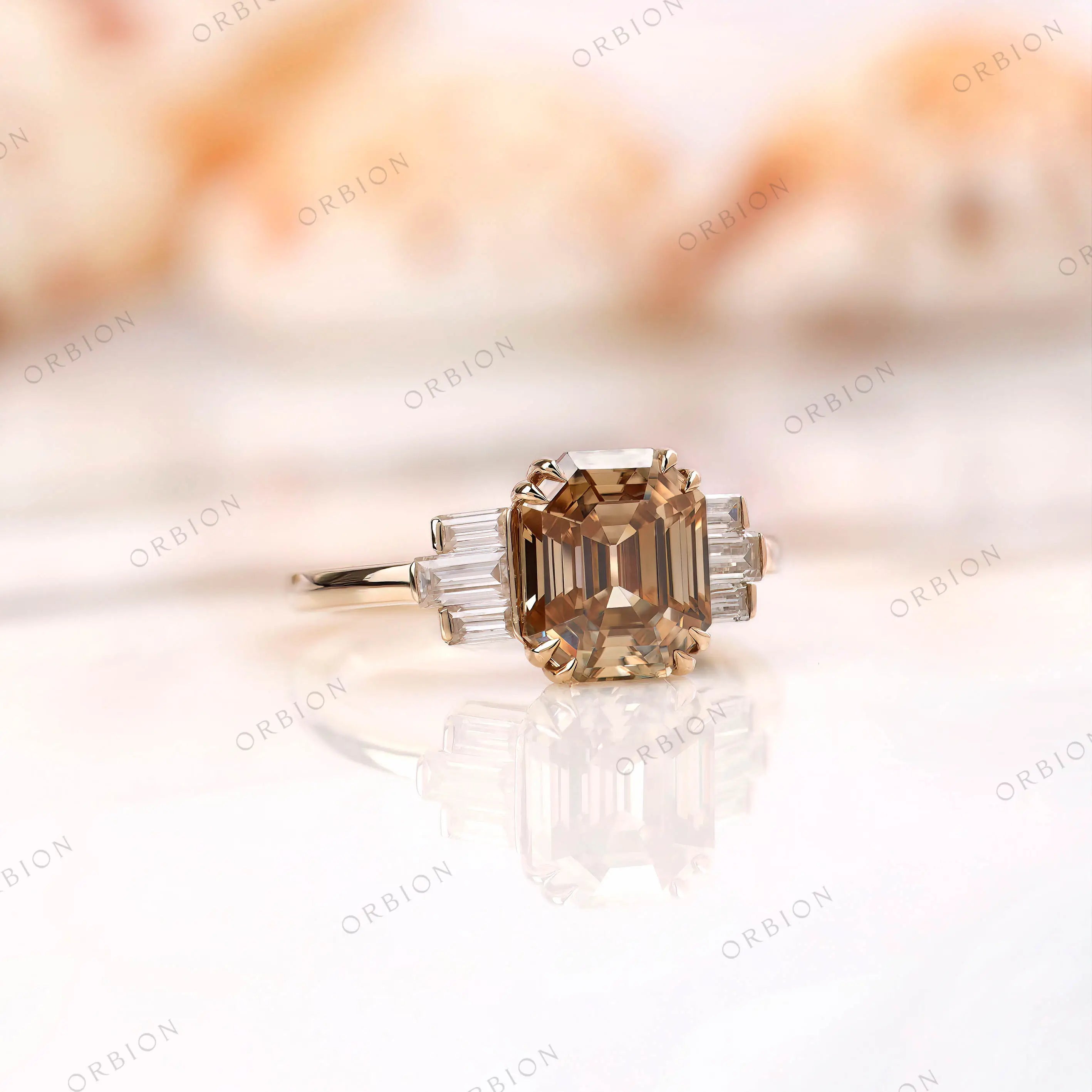 Side view of engagement ring showcasing emerald cut moissanite with baguettes