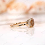 Profile shot of champagne moissanite ring with side baguette stones