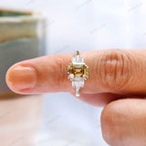 Side profile view of the engagement ring with baguettes on hand
