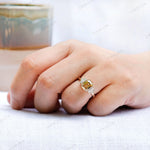 Top view of champagne moissanite ring with emerald cut center stone