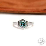 Front view of hexagon blue-green moissanite solitaire ring