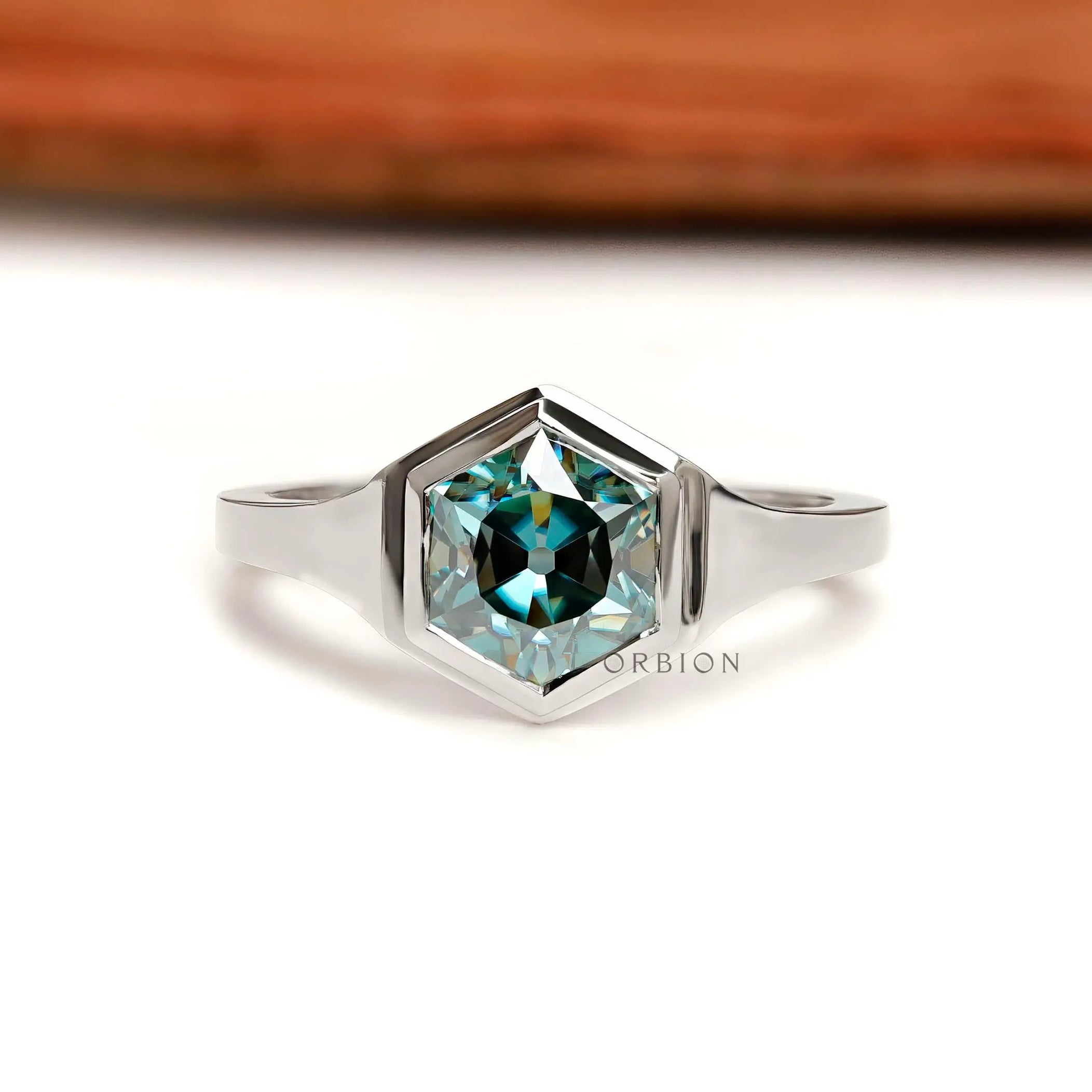 Front view of hexagon blue-green moissanite solitaire ring