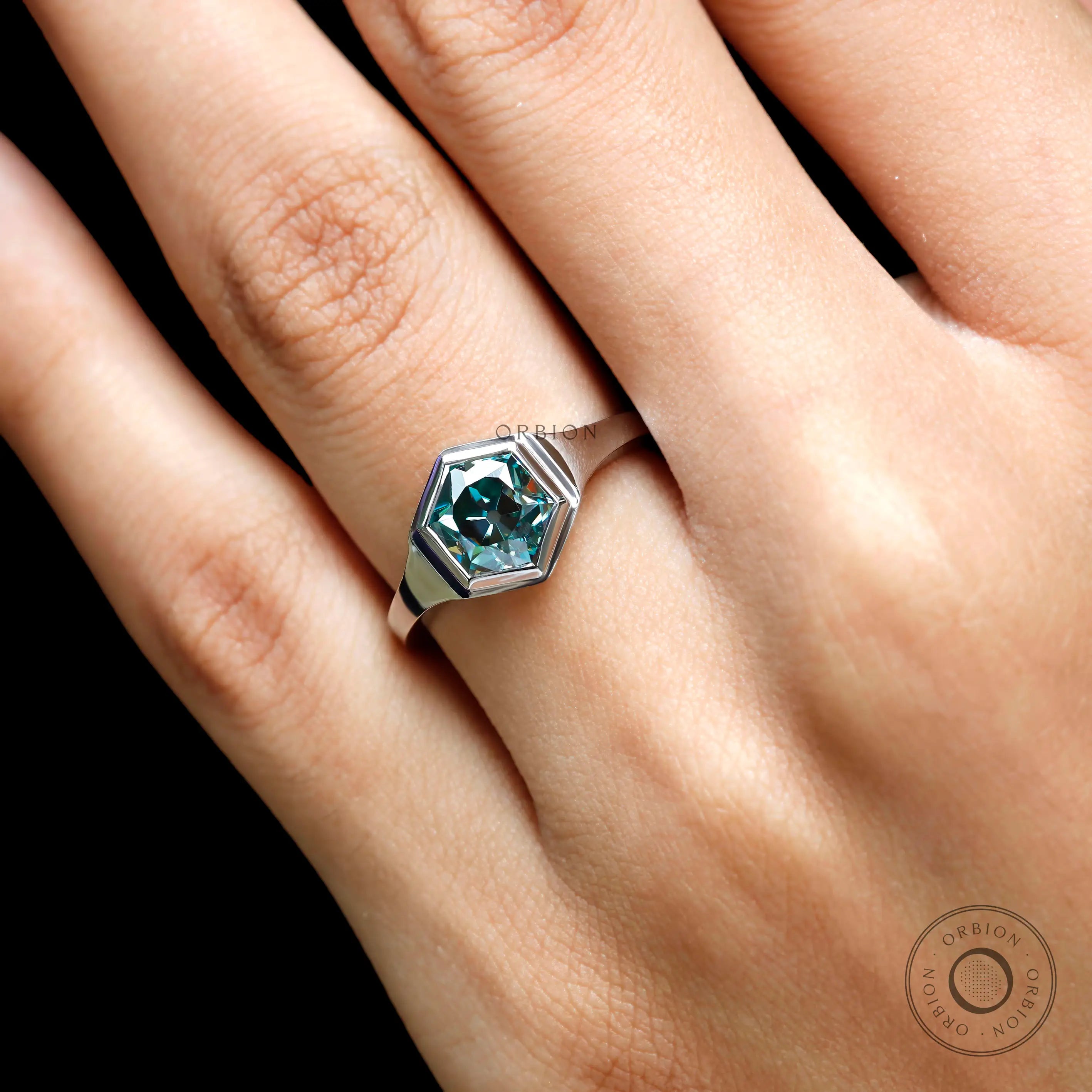 Close-up view of blue-green hexagon moissanite