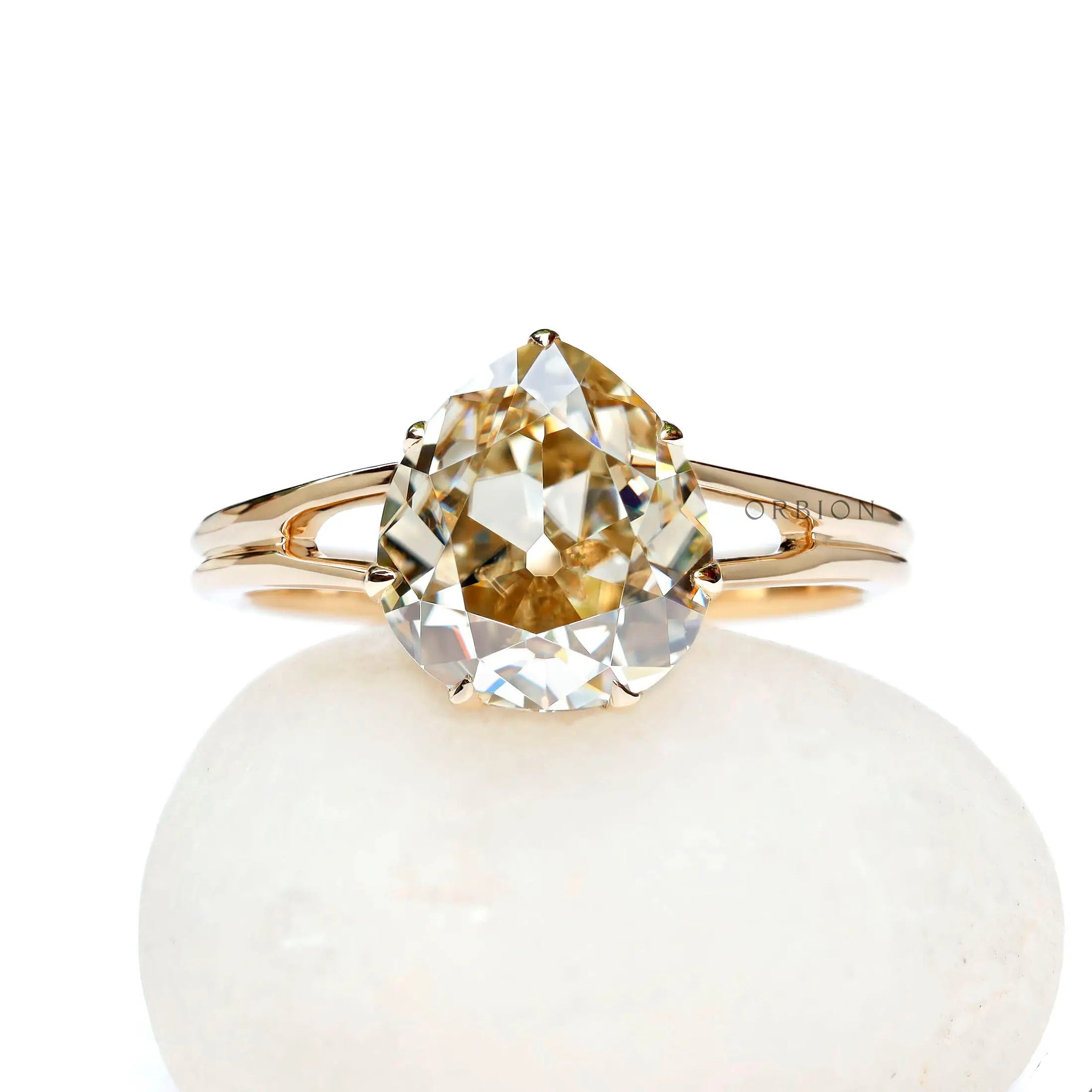 Old mine cut pear light champagne moissanite split shank engagement ring in yellow gold