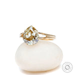 Front view of pear old mine cut champagne moissanite split shank ring in yellow gold