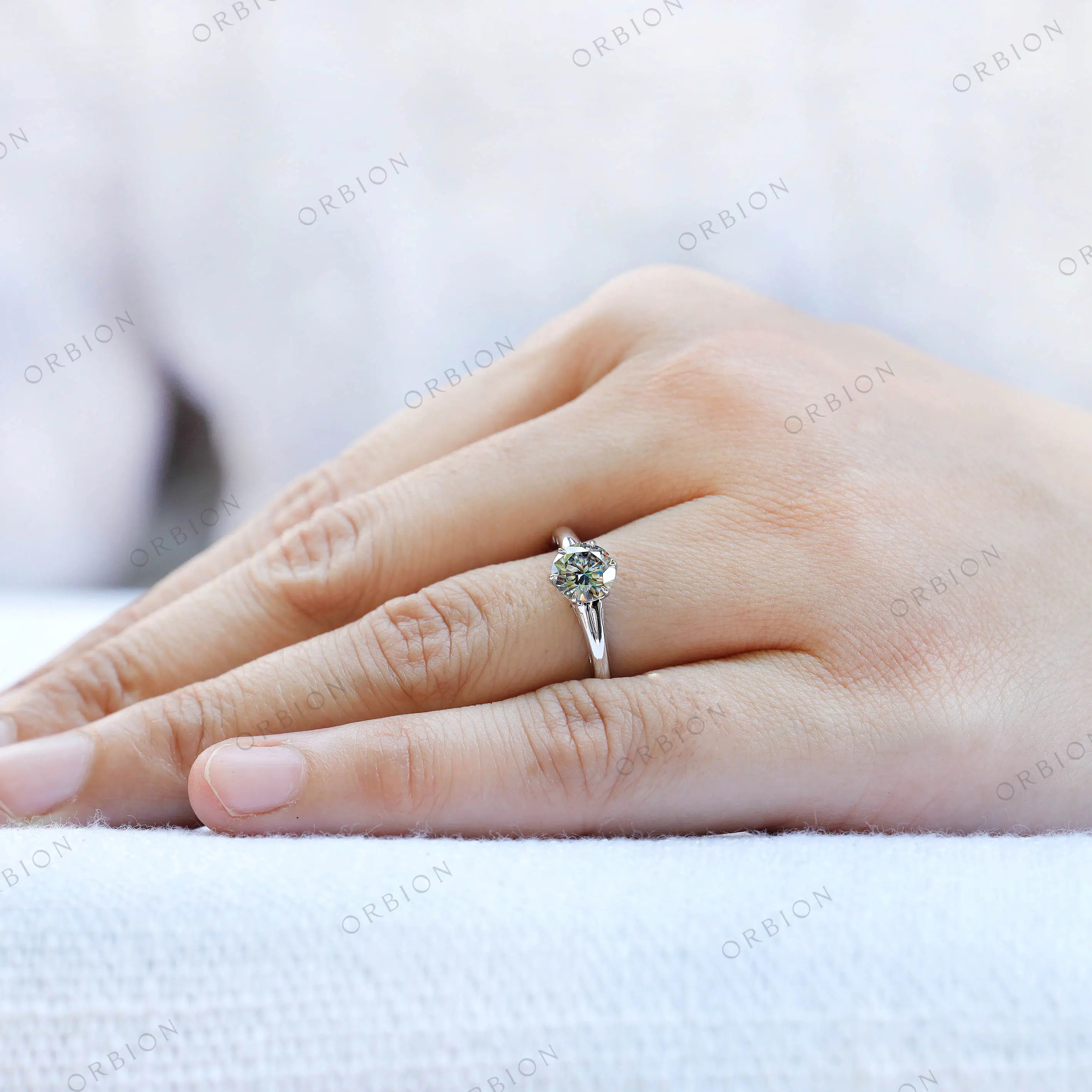 White gold solitaire ring with grey moissanite on fingure