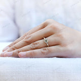 Minimalist moissanite engagement ring on finger