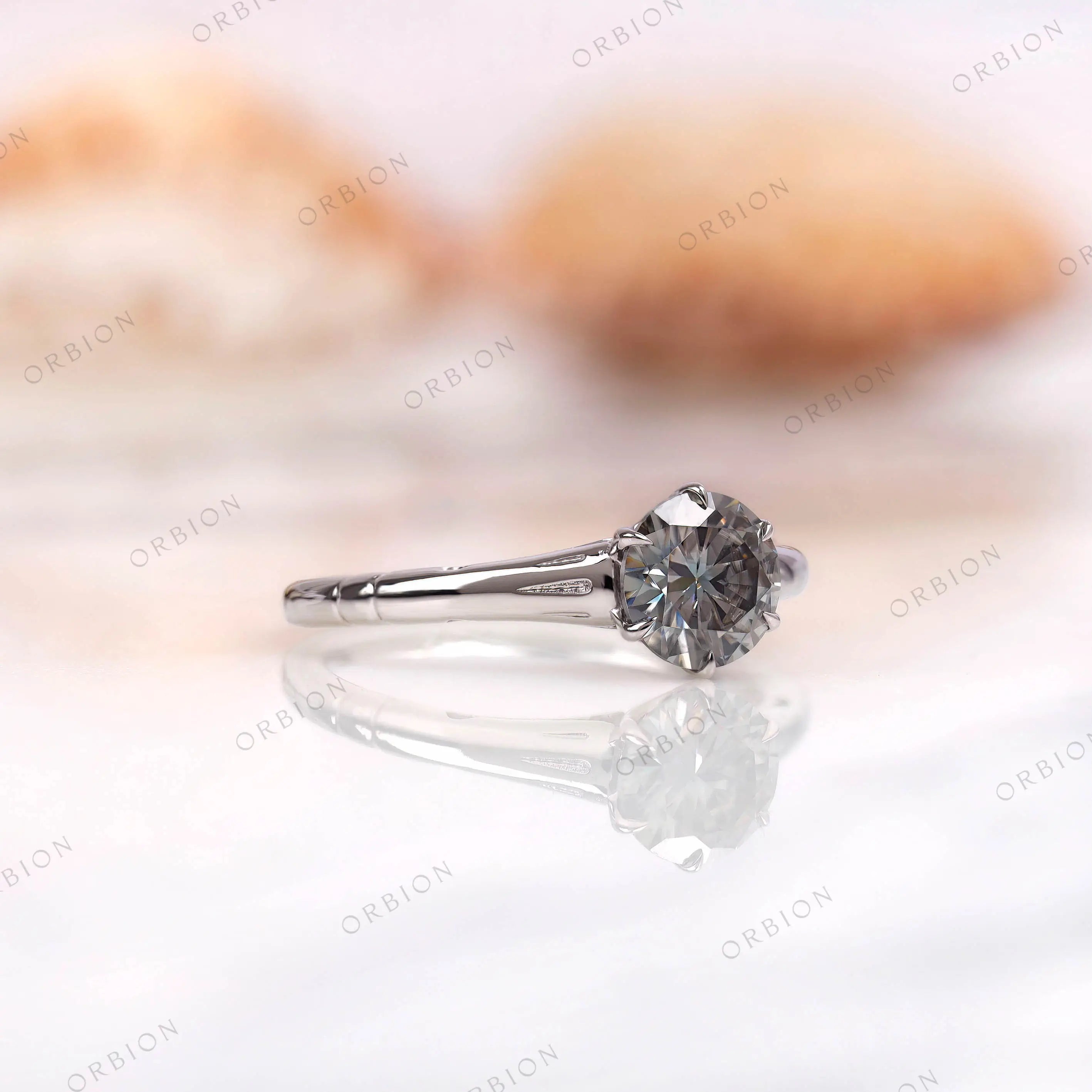 Side profile of round grey moissanite solitaire ring