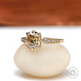 Side view of the Elongated Cushion Moissanite Engagement Ring with round side stones in 18K yellow gold setting.