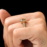 A close-up of the elongated cushion Moissanite engagement ring, highlighting the center stone and side Moissanite accents.