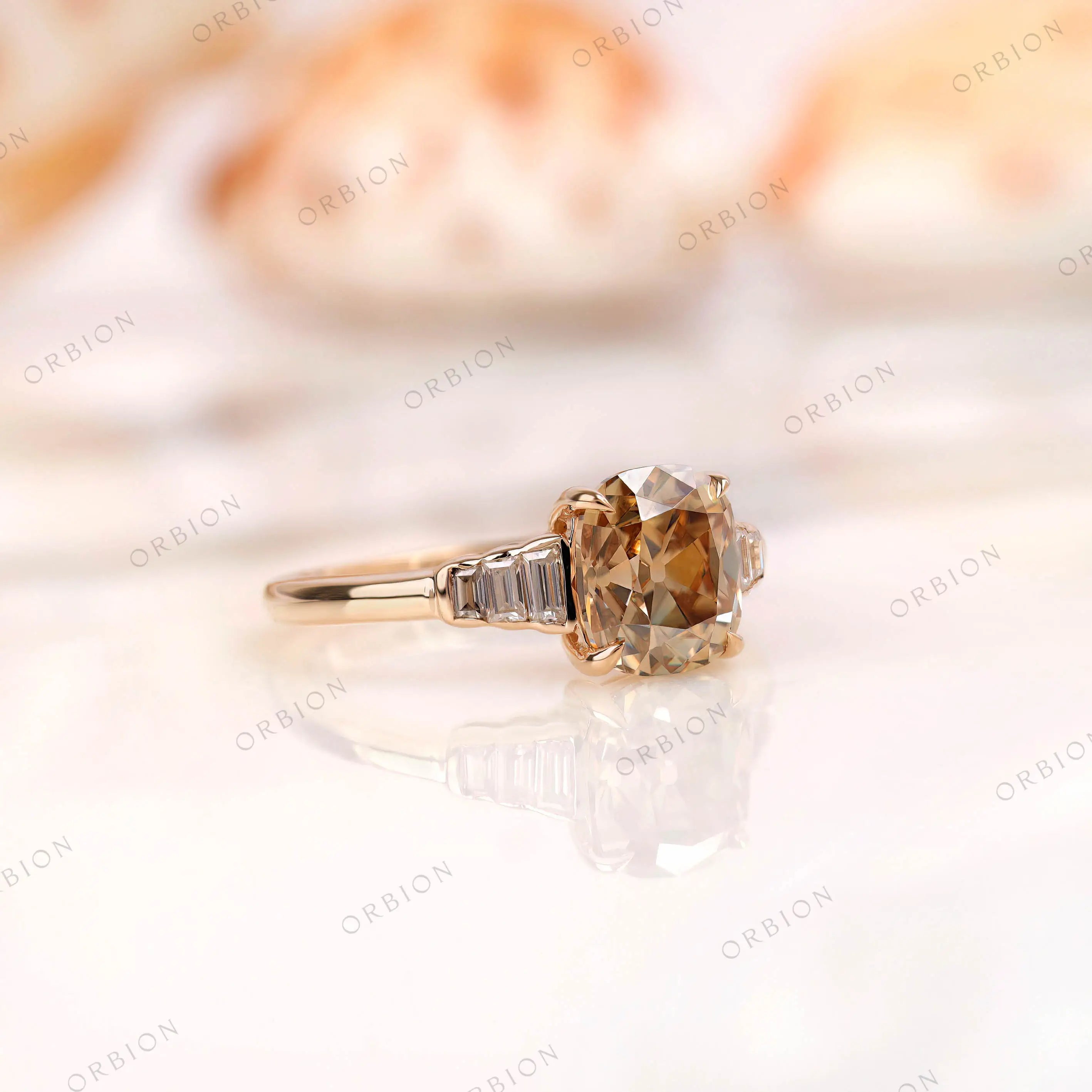 Close side detail of baguette step cut side stones on gold band