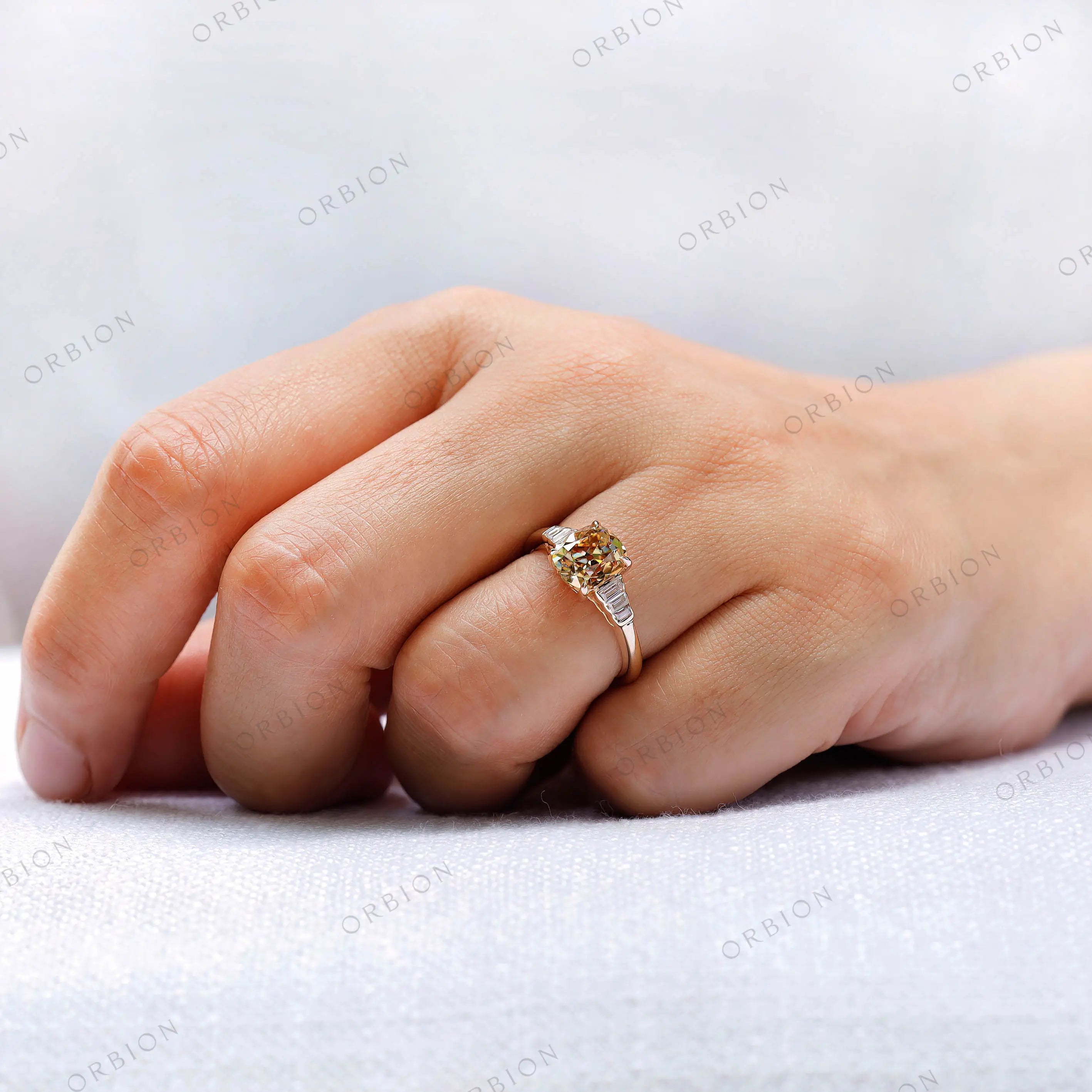 Ring on finger showing scale of elongated cushion center stone