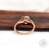 View of the back of the ring, highlighting the prong setting and tapered band in 10K rose gold.