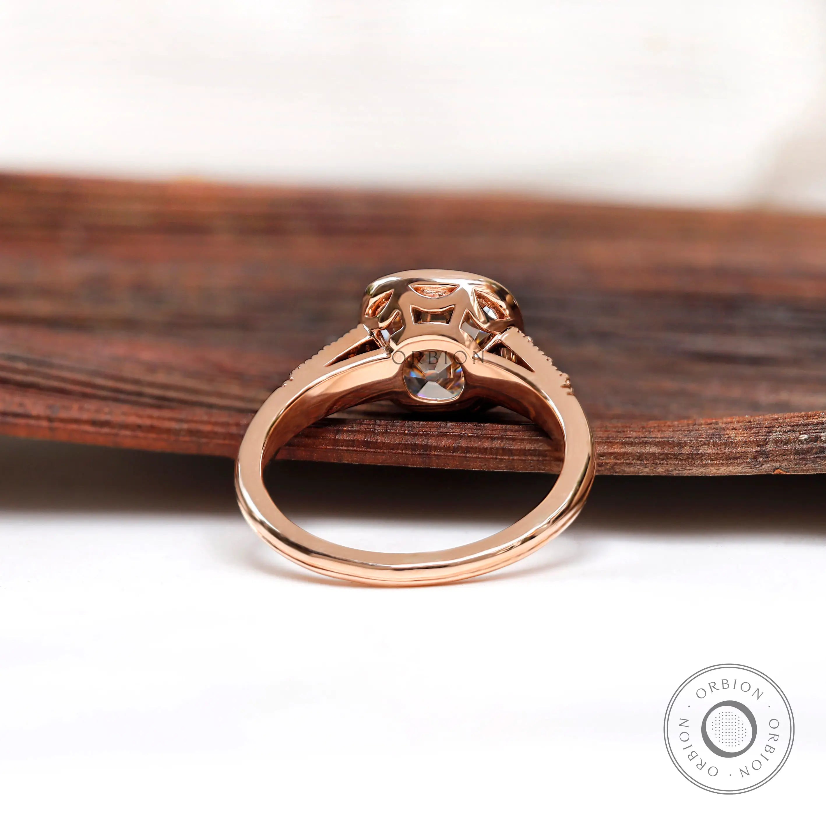 View of the back of the ring, highlighting the prong setting and tapered band in 10K rose gold.