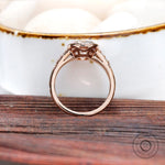 Close-up of the ring, showing the elongated cushion moissanite with the round brilliant-cut side stones.