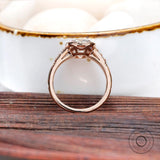 Close-up of the ring, showing the elongated cushion moissanite with the round brilliant-cut side stones.