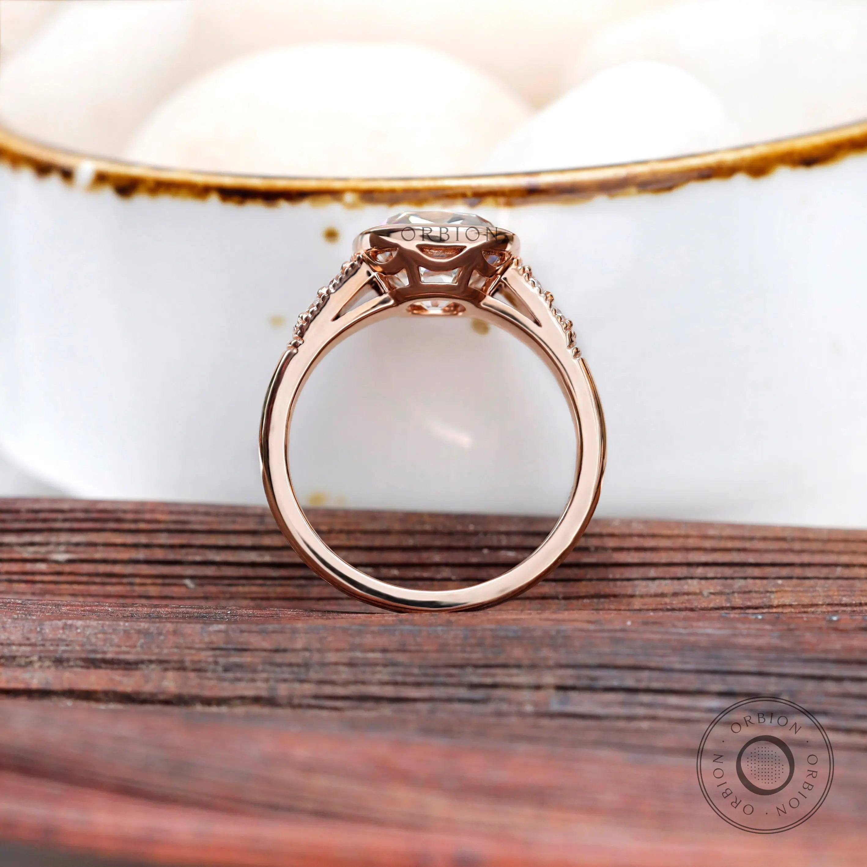 Close-up of the ring, showing the elongated cushion moissanite with the round brilliant-cut side stones.