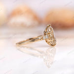 Side view of champagne moissanite pear ring with side stones