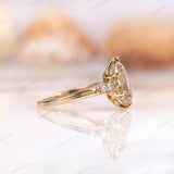 Side view of champagne moissanite pear ring with side stones