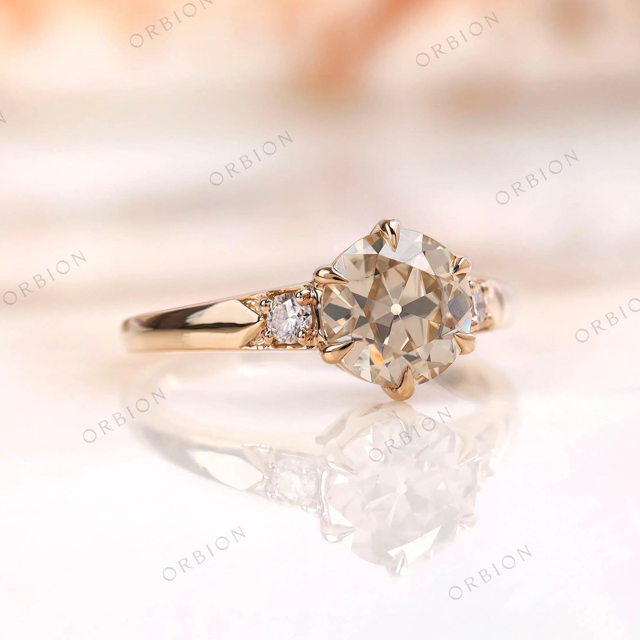 Vintage three stone engagement ring with round champagne moissanite center