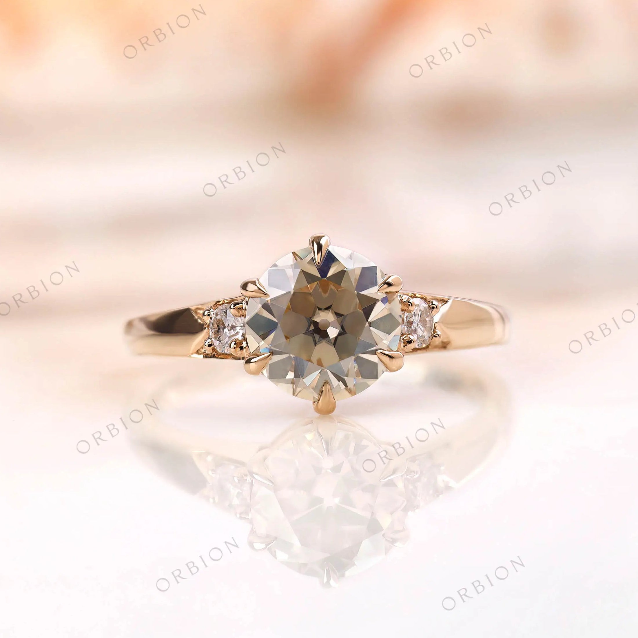 Old european cut light champagne moissanite three stone engagement ring in yellow gold