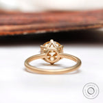 Back view of the round Old European Cut light champagne moissanite solitaire engagement ring in 10K yellow gold.