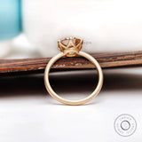 Round Old European Cut light champagne moissanite solitaire engagement ring in yellow gold with a polished band.